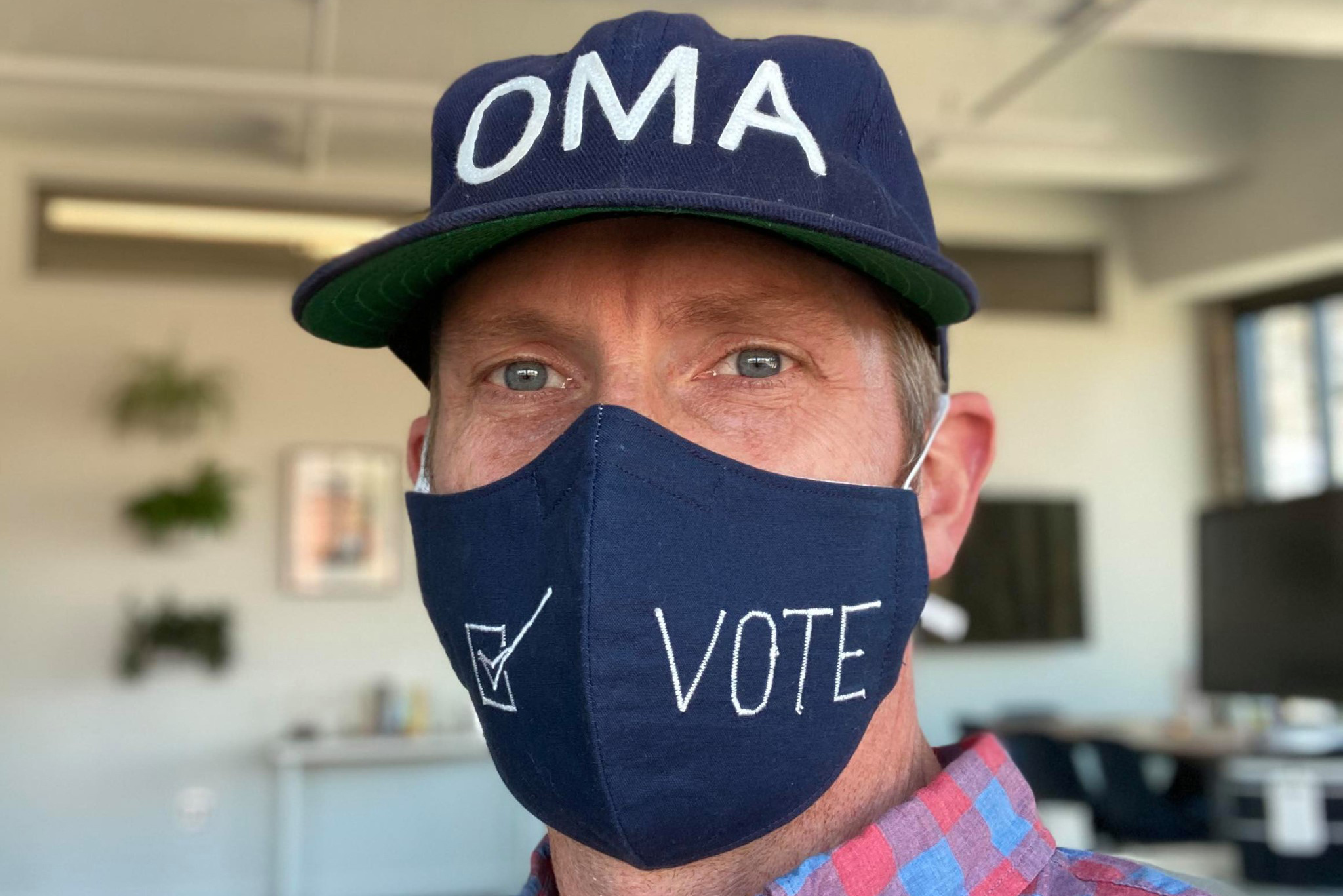 Closeup of Craig Moody with OMA hat and VOTE face mask